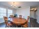 Cozy dining room features a classic chandelier and rustic wooden table set for Gathering meals at 165 Infinity Dr, Dorchester, SC 29437
