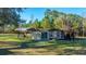 Exterior features a shed, with a carport on a grassy lot surrounded by trees at 165 Infinity Dr, Dorchester, SC 29437