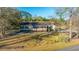Aerial view of a charming home with a screened-in porch, set amidst lush greenery and mature trees at 165 Infinity Dr, Dorchester, SC 29437