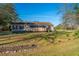 Aerial view of a charming home with a screened-in porch, set amidst lush greenery and mature trees at 165 Infinity Dr, Dorchester, SC 29437