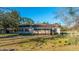 The home has a screened-in porch, shuttered windows, and a roof with a chimney nestled in a wooded area at 165 Infinity Dr, Dorchester, SC 29437