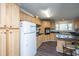 Well-lit kitchen features black countertops, light wood cabinetry, and lots of storage at 165 Infinity Dr, Dorchester, SC 29437