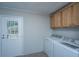 Functional laundry room with included washer, dryer, cabinets, and access to the outside at 165 Infinity Dr, Dorchester, SC 29437