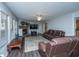 Cozy living room features a stone fireplace, plush leather seating, and neutral rug at 165 Infinity Dr, Dorchester, SC 29437