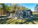 A shed features ample natural light through multiple windows and a sliding glass door at 165 Infinity Dr, Dorchester, SC 29437