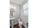 Bright powder room featuring a pedestal sink, stylish fixtures, and natural light at 1800 Poplar Grove Pl, Summerville, SC 29483