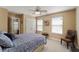 Bedroom with a ceiling fan and two windows offers ample natural light; the room is decorated in calm, neutral tones at 1800 Poplar Grove Pl, Summerville, SC 29483