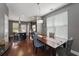 Dining area showcasing a dark wood table, stylish chairs, and abundant natural light from a large window at 1800 Poplar Grove Pl, Summerville, SC 29483