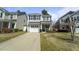 Inviting two-story home with a well-manicured lawn and cozy front porch, nestled in a suburban neighborhood at 1800 Poplar Grove Pl, Summerville, SC 29483