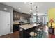 Spacious kitchen featuring dark cabinets, granite countertops, an island with seating, and modern appliances at 1800 Poplar Grove Pl, Summerville, SC 29483