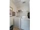 Laundry room with washer, dryer and shelf storage is a convenient space for laundry tasks, with framed artwork on the wall at 1800 Poplar Grove Pl, Summerville, SC 29483