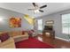Open living room area featuring hardwood floors, a ceiling fan, and staircase access to the upper level at 1800 Poplar Grove Pl, Summerville, SC 29483
