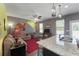 Open living room features a large sofa, ceiling fan, and a decorative red rug for a cozy and inviting atmosphere at 1800 Poplar Grove Pl, Summerville, SC 29483