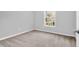 Bedroom with neutral walls and carpet, showcasing natural light through the window at 1810 Laura Creek Rd, Charleston, SC 29412