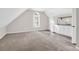 Bonus room offering ample floor space and kitchenette with white cabinets at 1810 Laura Creek Rd, Charleston, SC 29412
