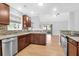 Well-equipped kitchen with stainless steel appliances, granite countertops, and hardwood floors, open to the living room at 1810 Laura Creek Rd, Charleston, SC 29412