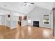 Inviting living room seamlessly connects to the kitchen, featuring hardwood floors, fireplace, and ample natural light at 1810 Laura Creek Rd, Charleston, SC 29412