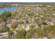 Aerial view showcasing neighborhood homes surrounded by lush trees and a scenic lake nearby at 1874 Rifle Range Rd, Mount Pleasant, SC 29464