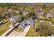 Stunning aerial view of a charming two-story home featuring a well-manicured lawn and a solar panel roof at 1874 Rifle Range Rd, Mount Pleasant, SC 29464