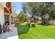 Spacious backyard with lush artificial turf, mature tree and outdoor lounge area with a fire pit at 1874 Rifle Range Rd, Mount Pleasant, SC 29464