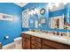 Bright bathroom with double vanity, granite countertop, and a decorative mirror at 1874 Rifle Range Rd, Mount Pleasant, SC 29464