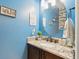 Updated bathroom with granite countertop, dark wood vanity, and round mirror at 1874 Rifle Range Rd, Mount Pleasant, SC 29464