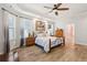 Cozy bedroom with a tray ceiling, wood-look floors, and a beautiful picture above the bed at 1874 Rifle Range Rd, Mount Pleasant, SC 29464