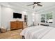 Bright bedroom with wood-look floors and a walk-in closet, with a large TV at 1874 Rifle Range Rd, Mount Pleasant, SC 29464