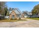 Charming two-story home featuring stone accents, professional landscaping, and a well-maintained lawn at 1874 Rifle Range Rd, Mount Pleasant, SC 29464