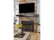 Cozy fireplace with stone surround, wooden mantle, and built-in cabinets at 1874 Rifle Range Rd, Mount Pleasant, SC 29464