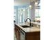Close-up of kitchen island with granite countertop, sink and stainless steel dishwasher at 1874 Rifle Range Rd, Mount Pleasant, SC 29464