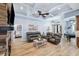 Open-concept living area with coffered ceilings, stone fireplace, and comfortable leather seating at 1874 Rifle Range Rd, Mount Pleasant, SC 29464
