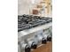 Close up of the KitchenAid stove with black grates, stainless steel finish, and stylish knobs at 1874 Rifle Range Rd, Mount Pleasant, SC 29464