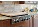A KitchenAid stove with a wooden cutting board cover, surrounded by elegant countertops and cabinets at 1874 Rifle Range Rd, Mount Pleasant, SC 29464