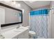 Well-lit bathroom with a vanity and blue shower curtain at 188 Bamert St, Summerville, SC 29483