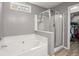 Bathroom featuring a walk-in shower, soaking tub, and walk-in closet at 188 Bamert St, Summerville, SC 29483