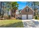 Charming two-story brick home with a well-manicured lawn, a two-car garage, and a lovely palm tree at 188 Bamert St, Summerville, SC 29483