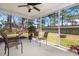 Relaxing screened porch featuring outdoor furniture and views of the fenced backyard at 188 Bamert St, Summerville, SC 29483