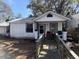 Exterior of a one-story house with a ramp and front porch with chairs and a grill at 1907 Helm Ave, North Charleston, SC 29405