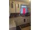 Kitchen area showcasing the sink, cabinets, decorations, and a window at 1907 Helm Ave, North Charleston, SC 29405