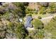 Stunning aerial view of a beautiful home with a pool, lush landscaping, and a private driveway at 1988 Long Creek Rd, Wadmalaw Island, SC 29487