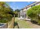 The backyard features a sunroom, privacy fence, and mature trees at 1988 Long Creek Rd, Wadmalaw Island, SC 29487