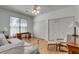 Bright bedroom with hardwood floors, a window view, and double-door closets at 1988 Long Creek Rd, Wadmalaw Island, SC 29487