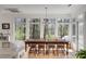 Inviting dining room with large windows providing scenic backyard views and natural light at 1988 Long Creek Rd, Wadmalaw Island, SC 29487