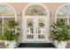 Charming front entrance featuring double doors, sidelights, and transom window at 1988 Long Creek Rd, Wadmalaw Island, SC 29487