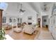Cozy living room showcasing fireplace, cathedral ceiling and comfortable seating at 1988 Long Creek Rd, Wadmalaw Island, SC 29487
