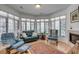 Inviting living room with bay windows, a fireplace, and comfortable seating for relaxation at 1988 Long Creek Rd, Wadmalaw Island, SC 29487