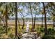 A view of a wooden boardwalk heading to the water at 1988 Long Creek Rd, Wadmalaw Island, SC 29487