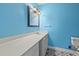 Bright bathroom features a lengthy white vanity and attractive grey patterned tile floors at 201 Commons Way, Goose Creek, SC 29445
