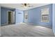 Light-filled blue bedroom with neutral carpet and multiple windows with natural light at 201 Commons Way, Goose Creek, SC 29445